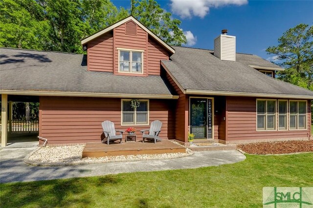 178 Country Way, Springfield, GA 31329 - back of house with a deck, a chimney, a shingled roof, a yard, and a carport