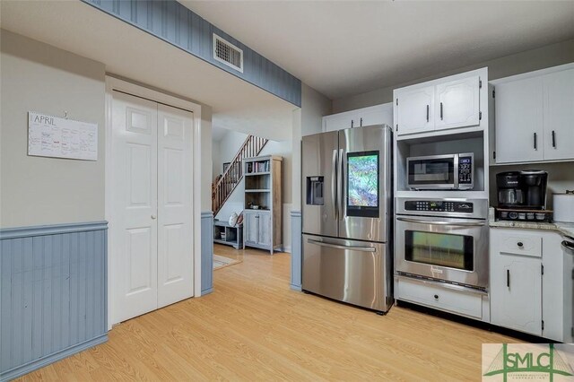 178 Country Way, Springfield, GA 31329 - kitchen featuring visible vents, light wood-style flooring, light countertops, stainless steel appliances, and white cabinetry