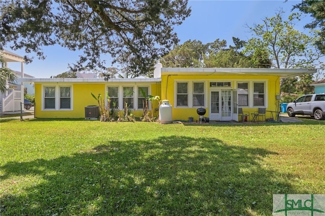 1508 Miller Ave, Tybee Island, GA 31328 - back of property with central air condition unit and a yard