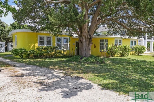 1508 Miller Ave, Tybee Island, GA 31328 - view of front facade featuring a front yard and stucco siding
