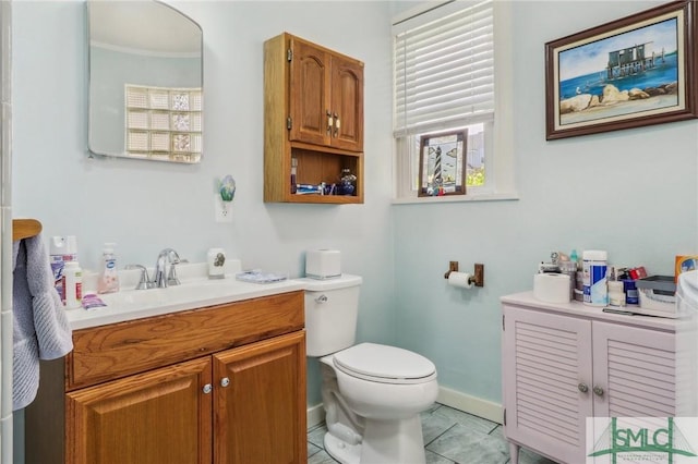 1508 Miller Ave, Tybee Island, GA 31328 - bathroom featuring crown molding, tile patterned floors, baseboards, vanity, and toilet