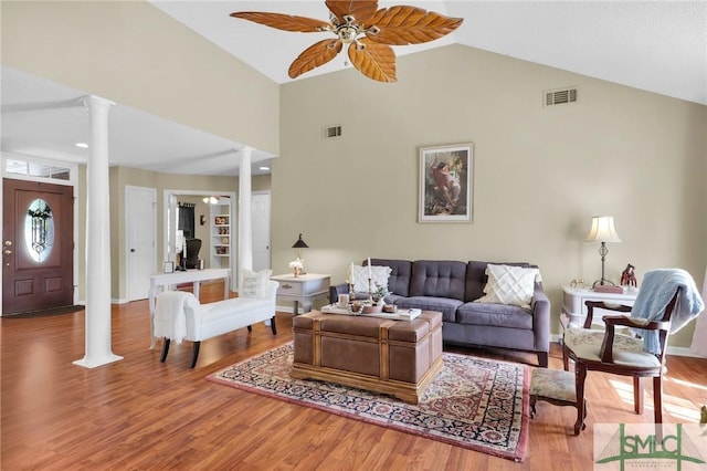 living area with visible vents, decorative columns, ceiling fan, and wood finished floors