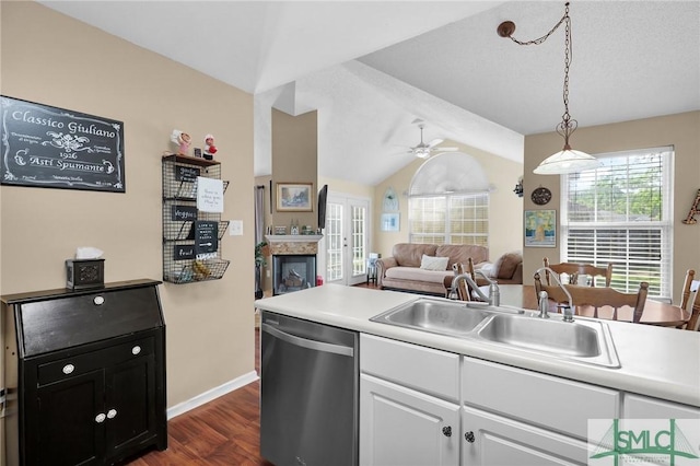 kitchen featuring stainless steel dishwasher, a ceiling fan, white cabinetry, a sink, and dark wood finished floors