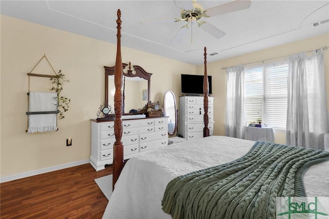 bedroom with ceiling fan, baseboards, visible vents, and wood finished floors