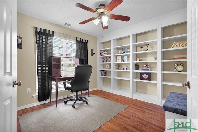 office area featuring ceiling fan, a textured ceiling, visible vents, wood finished floors, and baseboards