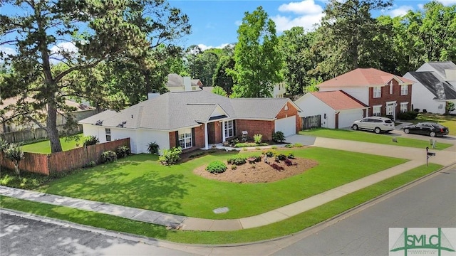 view of front facade featuring a front lawn, fence, brick siding, an attached garage, and driveway