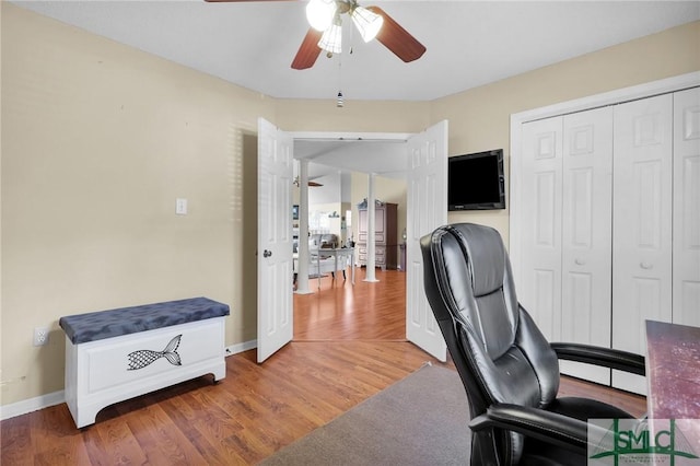 office with baseboards, light wood-style flooring, and ceiling fan