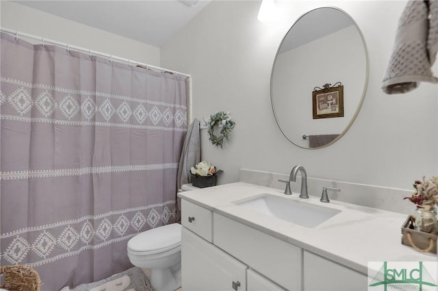 bathroom featuring toilet, curtained shower, and vanity