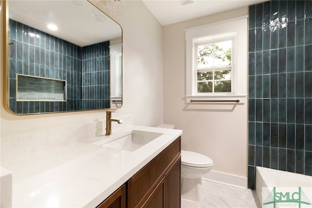 bathroom with toilet, baseboards, and vanity