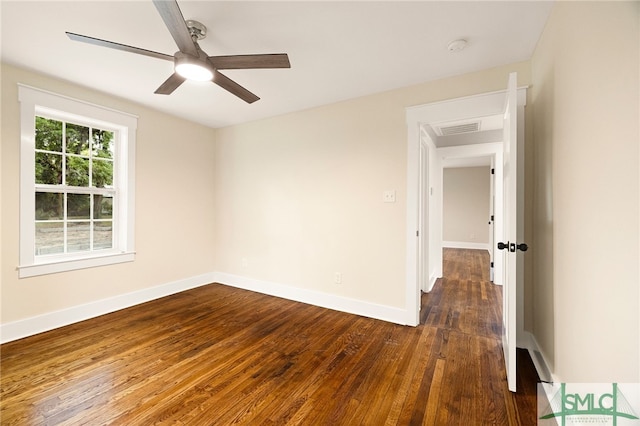 empty room featuring a ceiling fan, baseboards, visible vents, and dark wood-style floors