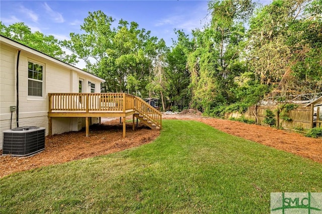 view of yard featuring stairway, central AC, a deck, and fence