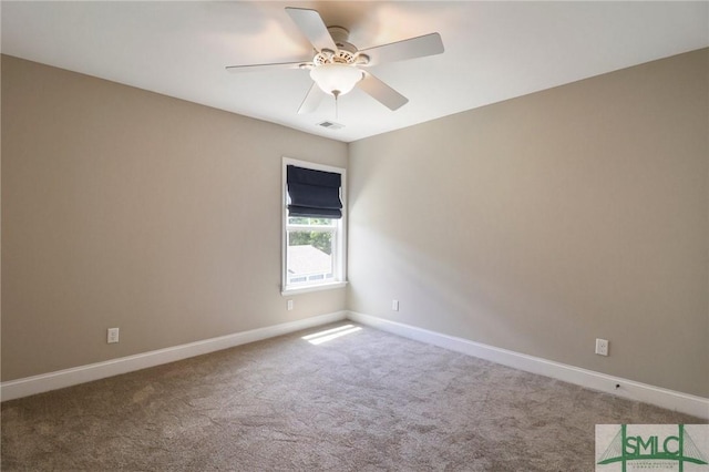 carpeted empty room featuring ceiling fan, visible vents, and baseboards