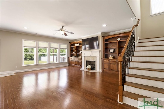 unfurnished living room featuring dark wood-style flooring, stairs, a fireplace, ceiling fan, and recessed lighting