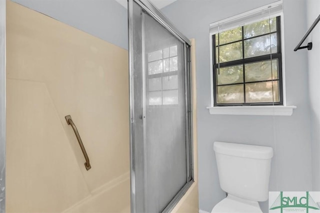 full bath with a shower with door and toilet