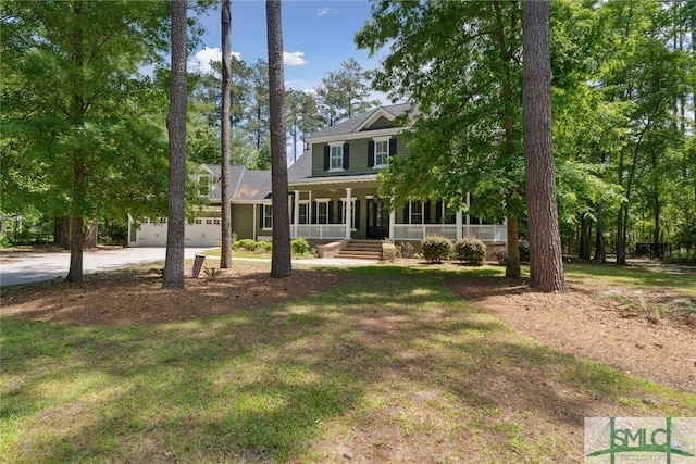 80 Hickory St, Richmond Hill, GA 31324 - view of front of property featuring a garage, a front lawn, a porch, and driveway