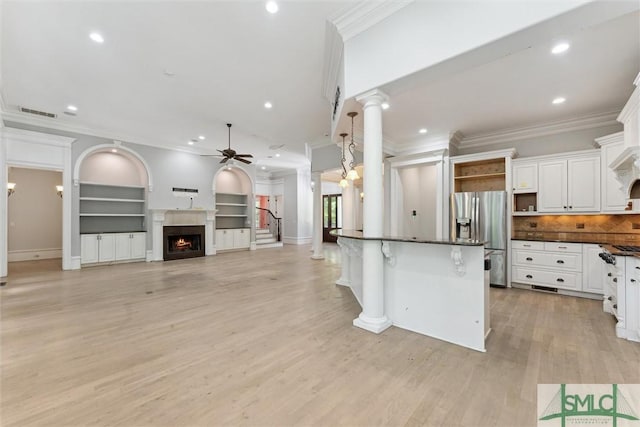 80 Hickory St, Richmond Hill, GA 31324 - kitchen with crown molding, open shelves, dark countertops, stainless steel fridge, and a ceiling fan