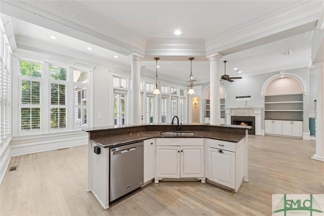 80 Hickory St, Richmond Hill, GA 31324 - kitchen with stainless steel dishwasher, ornamental molding, a lit fireplace, ornate columns, and a sink