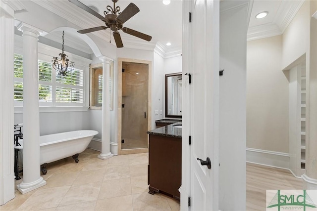 80 Hickory St, Richmond Hill, GA 31324 - bathroom featuring crown molding, decorative columns, a soaking tub, and a stall shower