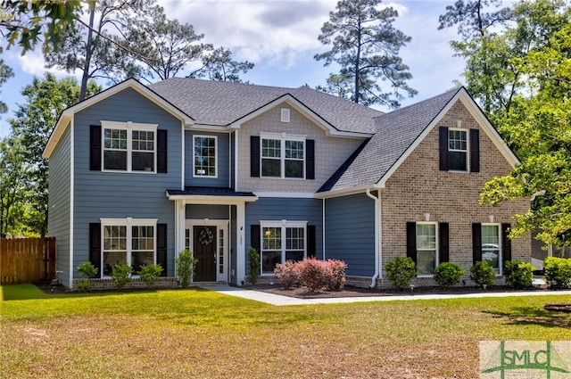 132 Cubbedge Dr, Rincon, GA 31326 - craftsman-style home with fence, a shingled roof, a front lawn, and brick siding