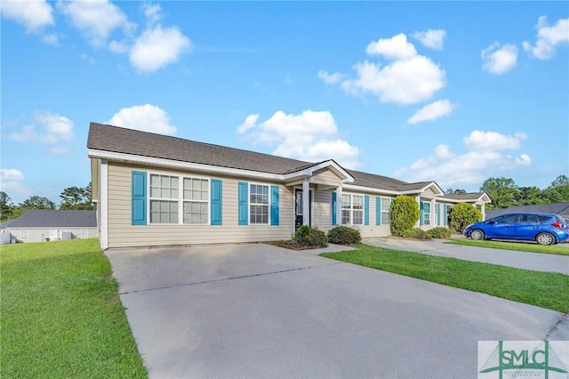 single story home featuring a front yard and concrete driveway
