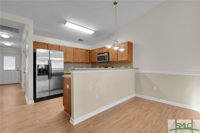 kitchen featuring stainless steel appliances, visible vents, brown cabinetry, and light wood-style floors