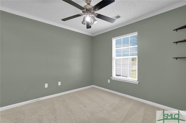 empty room featuring baseboards, ornamental molding, carpet, and visible vents