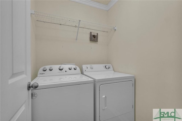 laundry room with laundry area, crown molding, and washing machine and clothes dryer
