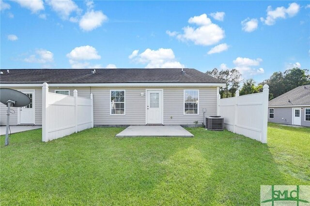rear view of property featuring a patio area, central air condition unit, a yard, and fence