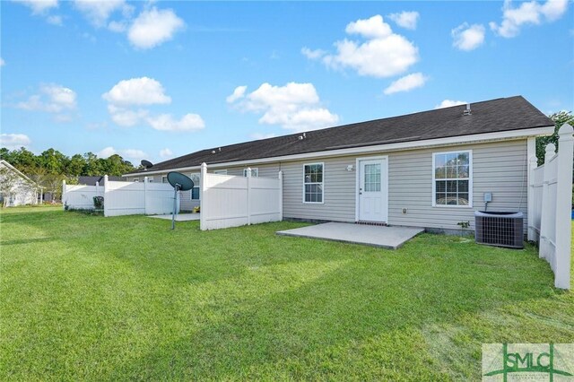 rear view of house with fence, a yard, cooling unit, and a patio area