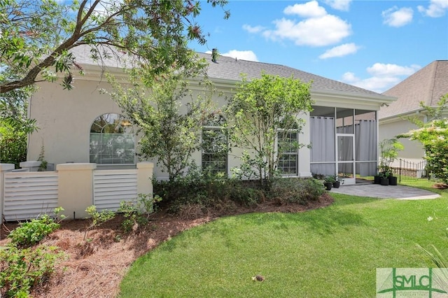 5 Lazy Hammock Ct, Savannah, GA 31419 - rear view of property featuring a lawn, stucco siding, a sunroom, and a patio