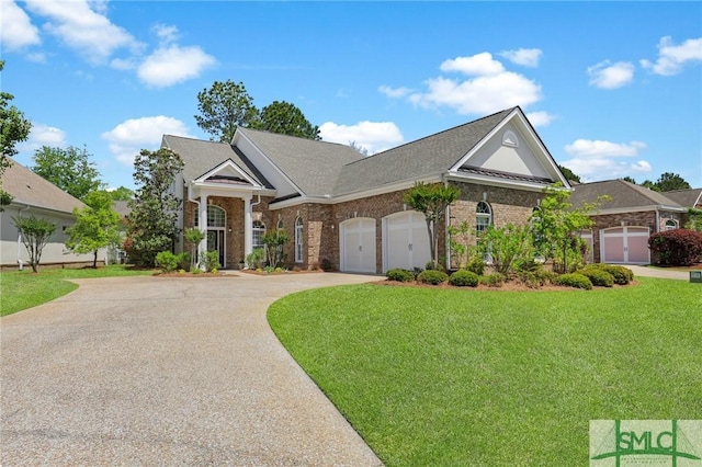 5 Lazy Hammock Ct, Savannah, GA 31419 - view of front facade with an attached garage, concrete driveway, a front yard, and brick siding