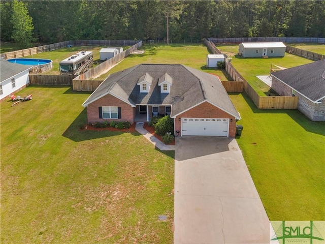 birds eye view of property featuring a view of trees