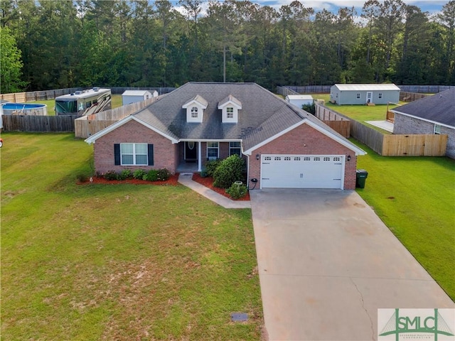 traditional-style house featuring concrete driveway, brick siding, a front yard, and a garage