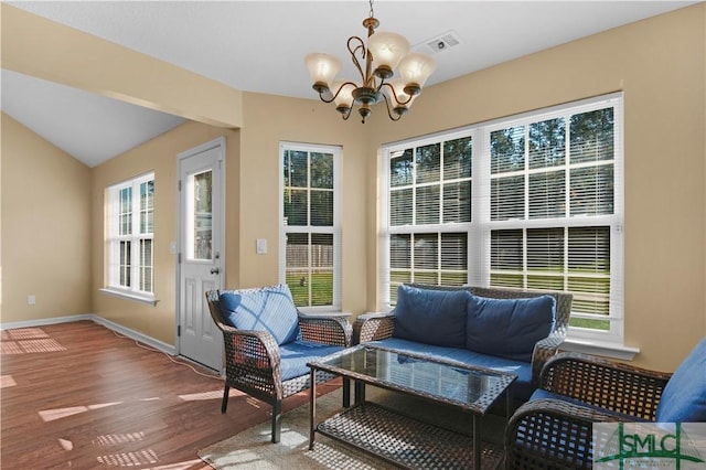 sunroom with visible vents and a notable chandelier