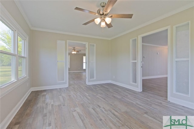 empty room with baseboards, a ceiling fan, wood finished floors, and ornamental molding