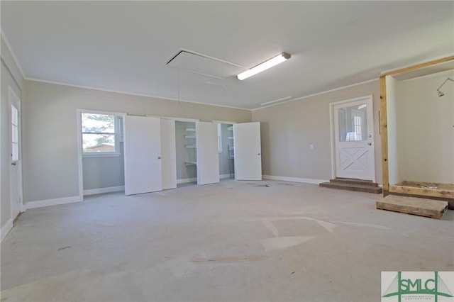 interior space with crown molding and attic access