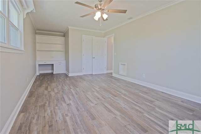 unfurnished bedroom with crown molding, baseboards, and light wood-type flooring