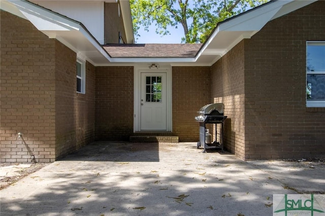 property entrance with brick siding