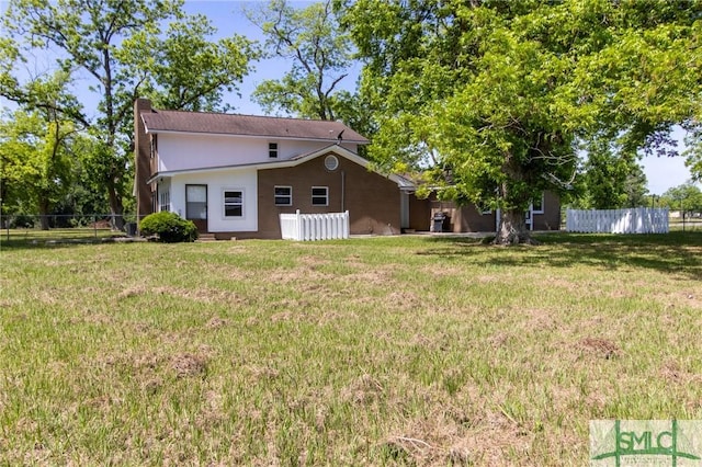 exterior space featuring fence and a yard