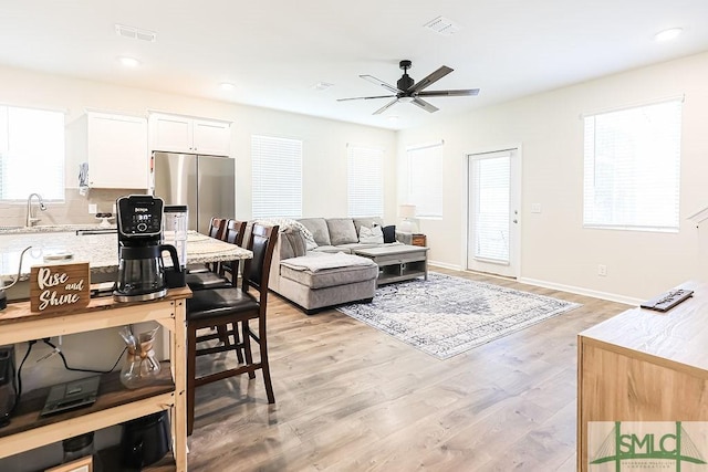 166 Benelli Dr, Pooler, GA 31322 - living area with ceiling fan, visible vents, a wealth of natural light, and light wood-style floors