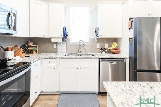 166 Benelli Dr, Pooler, GA 31322 - kitchen featuring a sink, backsplash, stainless steel appliances, and white cabinetry