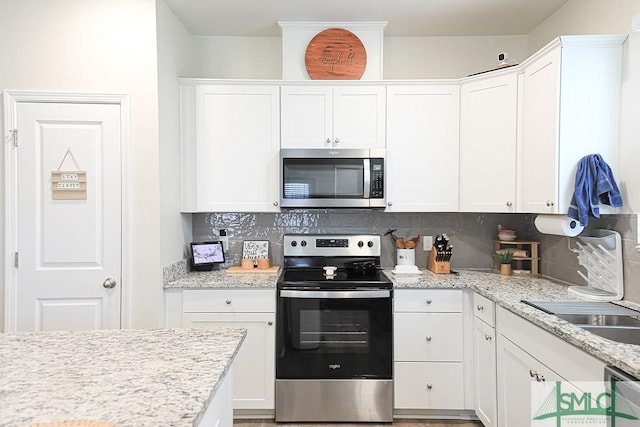 166 Benelli Dr, Pooler, GA 31322 - kitchen featuring white cabinetry, backsplash, and stainless steel appliances