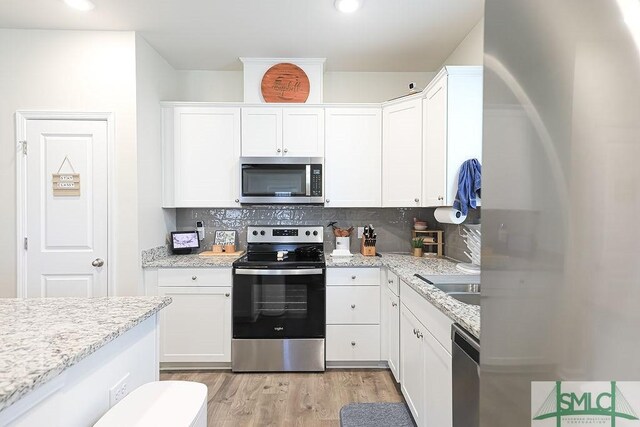 166 Benelli Dr, Pooler, GA 31322 - kitchen with a sink, appliances with stainless steel finishes, white cabinets, and backsplash