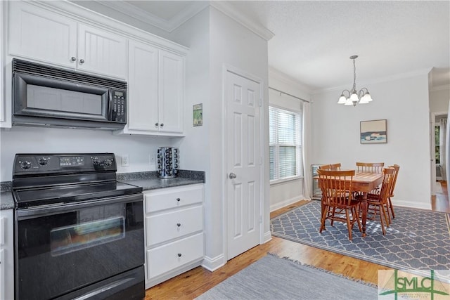 kitchen with crown molding, dark countertops, light wood-type flooring, white cabinetry, and black appliances