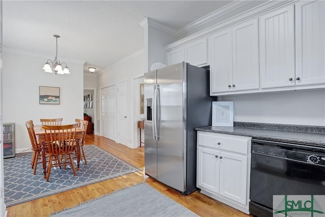 kitchen with white cabinets, a notable chandelier, stainless steel fridge, black dishwasher, and ornamental molding