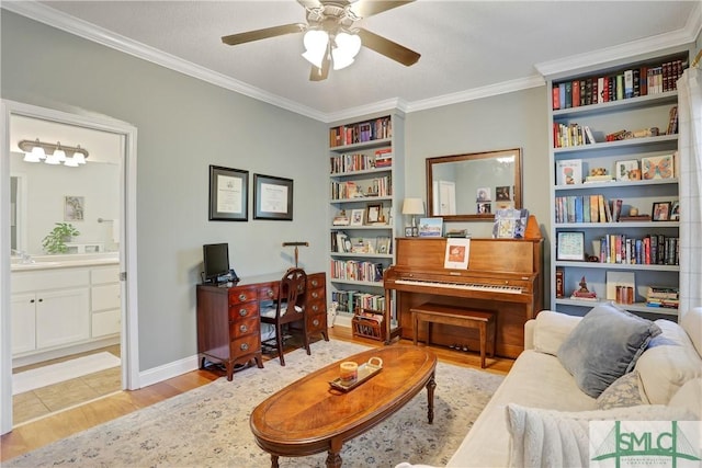 living area with crown molding, baseboards, ceiling fan, and wood finished floors