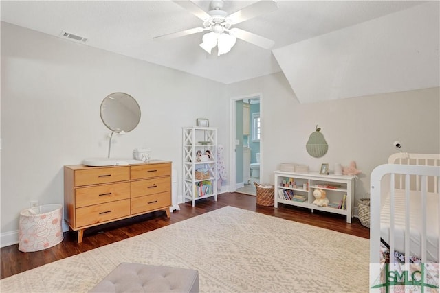 bedroom featuring baseboards, visible vents, and dark wood finished floors