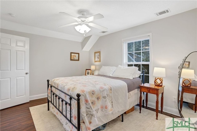 bedroom with baseboards, a ceiling fan, wood finished floors, and visible vents