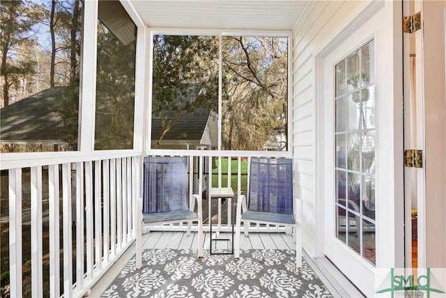 sunroom / solarium featuring baseboard heating and a healthy amount of sunlight