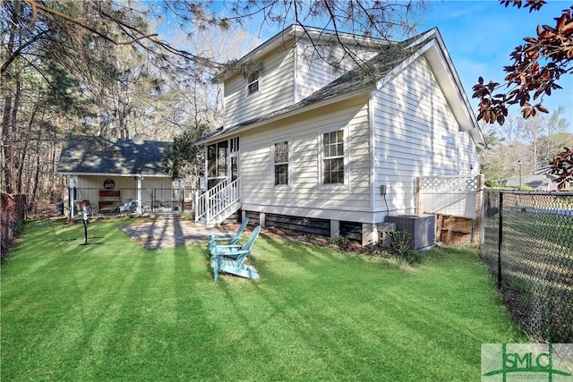 rear view of house with central AC, a fenced backyard, entry steps, a patio area, and a lawn